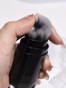 Close-up of soft gradient bristles on a 5-in-1 black retractable makeup brush