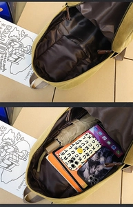 Detailed interior view of the khaki canvas backpack featuring main compartment and inner pocket
