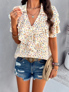 Detail of floral V-neck top with ruffle sleeves and elegant printed fabric texture