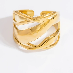 Detailed view of wide 18k gold plated open cuff bracelet with wavy irregular design