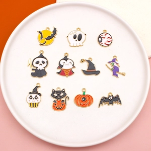 Detailed overhead view of assorted Halloween alloy enamel charms on a white round plate