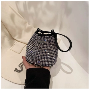 Close-up of black rhinestone bucket bag with silver metal chain and sparkling crystals