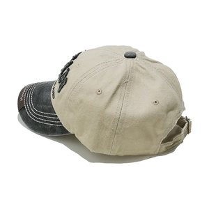 Detail view of the vintage baseball cap showing the embroidery and adjustable metal buckle