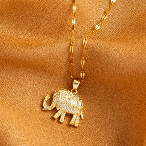 Golden stainless steel elephant necklace featuring sparkling zircon pave on textured gold fabric