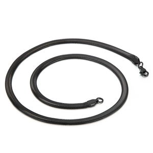 Sleek black stainless steel flat snake bone chain necklace arranged in a spiral coil