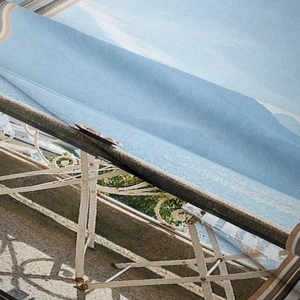Close-up of European courtyard landscape print on textured bohemian tapestry fabric
