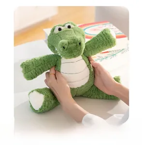 Close-up of green crocodile plush toy with soft fluffy fabric and white stitched belly