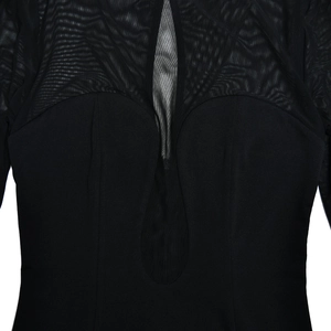 Detail of black long-sleeved dress with mesh patchwork and teardrop cutout at chest