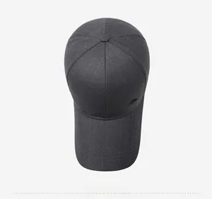 Top view of dark grey baseball cap showing six-panel crown and metal logo detail