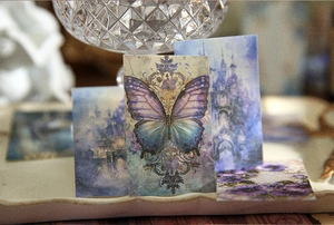 Detail of vintage scrapbooking paper featuring purple butterfly and dream castle art