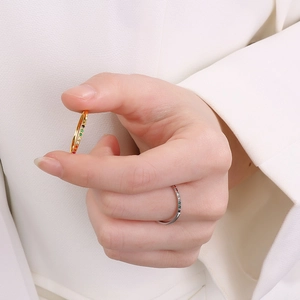 Close-up of minimalist gold and rose gold rings set with colorful zircon gemstones