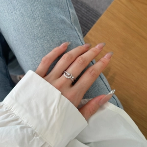 Close-up of S925 silver star and moon ring with cubic zirconia on a hand