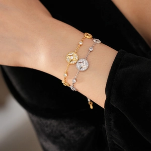 Close-up of gold and silver starburst pendant bracelets with sparkling cubic zirconia