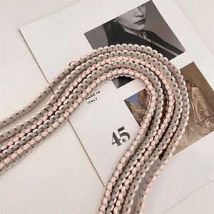 Detail view of pink and grey hand-woven adjustable shoulder strap for DIY bags