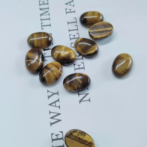 Macro shot of oval tiger eye stone cabochons with natural golden brown texture and luster