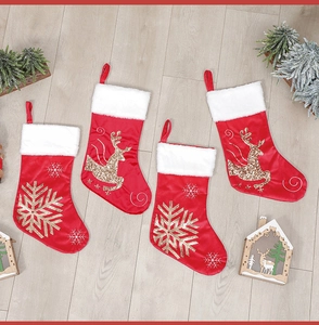 Set of four red velvet Christmas stockings with golden reindeer and snowflake embroidery