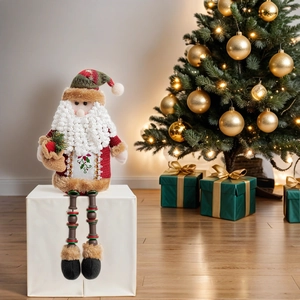 Detail of Santa Claus plush with beaded legs sitting near a festive Christmas tree