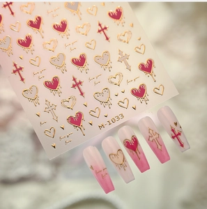 Detail of M-1033 gold heart and cross nail stickers on gradient pink false nails