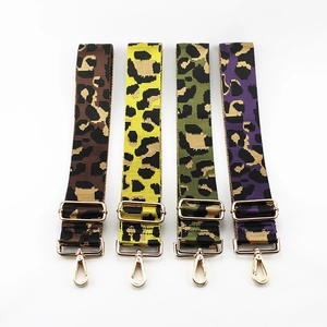 Adjustable leopard print bag straps with gold hardware in brown yellow green and purple