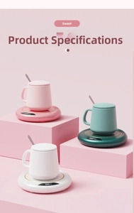 Close-up of smart cup warmer with digital display showing 88°C and ceramic mugs