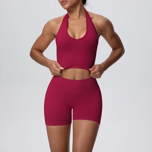 Detail showing burgundy ribbed yoga set with halter neck top and high-waist shorts