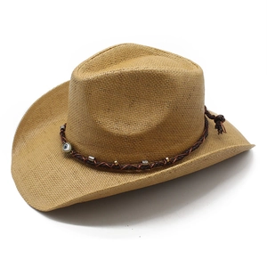 Ethnic straw cowboy hat with woven band and evil eye bead on a white background