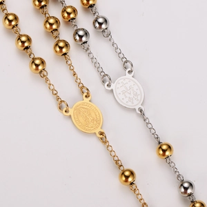 Religious rosary necklaces with gold and silver saint pendants on white background