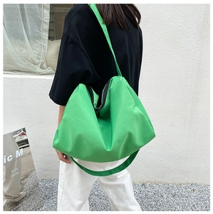Green nylon hobo bag shown in use with large capacity and round shape design
