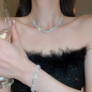 Luxury silver twisted jewelry set with shimmering crystals including necklace and bracelet