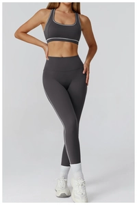 Detail of high-waisted yoga pants and racerback bra with white contrast piping