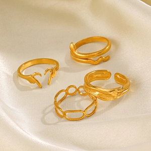 Set of 4 minimalist 18K gold-plated irregular geometric and heart rings on white silk fabric