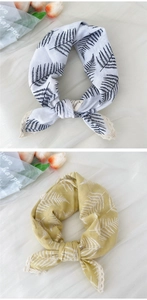 Detail of fern print lace-trimmed cotton linen headscarf in white and yellow tones