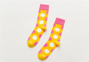 Detailed view of yellow crew socks with pink polka dots and ribbed cuffs for men