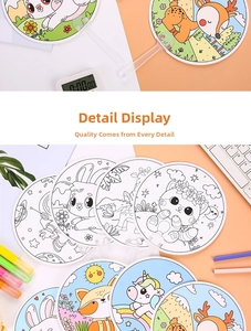 Close-up of children's DIY doodle fans featuring various cartoon animal outlines for coloring