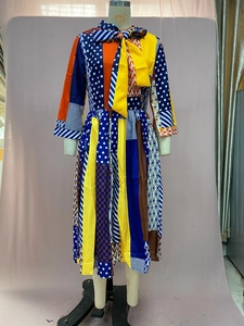 Detail of multi-color geometric print dress with bow-tie collar and three-quarter sleeves