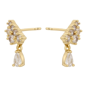 Macro detail of 18K gold plated earrings featuring pear-cut and round cubic zirconia