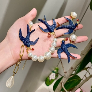 Vintage gold necklace and earrings set with blue enamel birds and white pearls