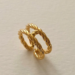 Close-up of double-layered twisted rope ring in 18K gold finish with open design