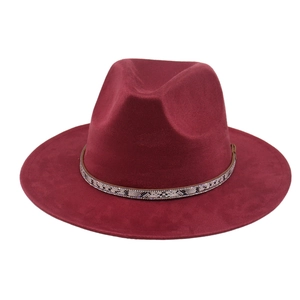 Detail of wine red fedora hat with snakeskin patterned band and rhinestone accents