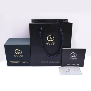 Confezione regalo nera minimalista con logo oro, borsa coordinata e manuale