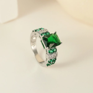 Close-up of S925 sterling silver ring featuring a large square green zircon and micro-pave setting