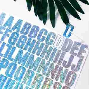 Detail of 1-inch glitter alphabet stickers with blue silver laser gradient effect