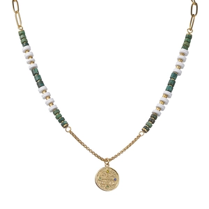 Beaded gold necklace with green accents and inscribed circular pendant on white background