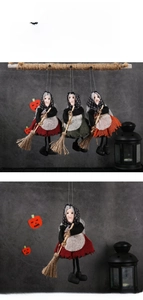 Three colorful Halloween witch dolls with mini brooms and polka dot scarves for party decor