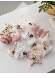 Nordic Christmas tree ornaments featuring stars and trees in warm pink and gold tones