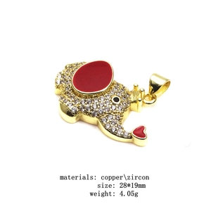 Detailed view of 28x19mm gold elephant pendant with zircons and red enamel inlay