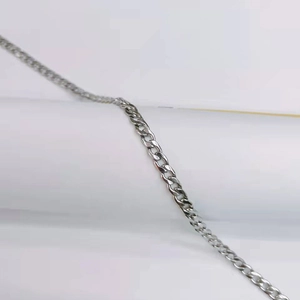 Detailed view of a polished silver stainless steel curb chain with hip hop style links
