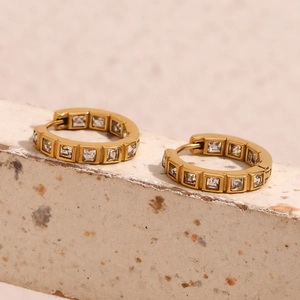 Detailed view of 18K gold plated stainless steel hoops with square zircon inlay