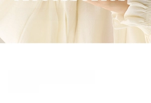 Detail view of cream pleated silk sleeve cuff showing soft material texture and design