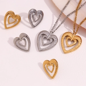 Close-up of heart-shaped earring and necklace set with dual-layer water-drop texture